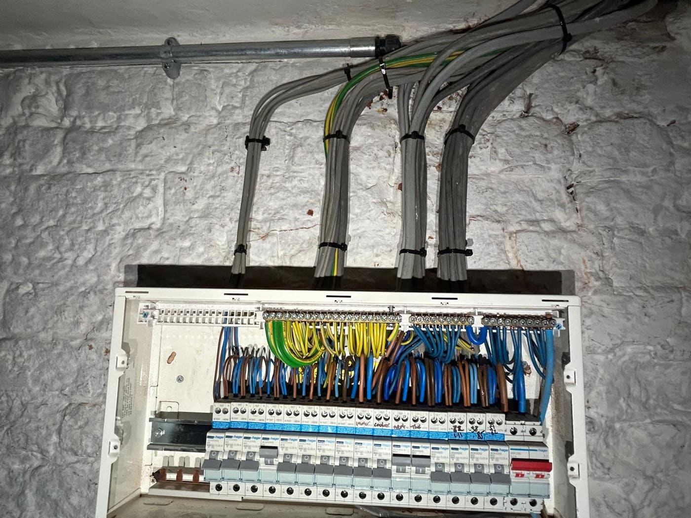After: tidy distribution board with neatly bundled cables in conduit by Green Electrical, Thanet